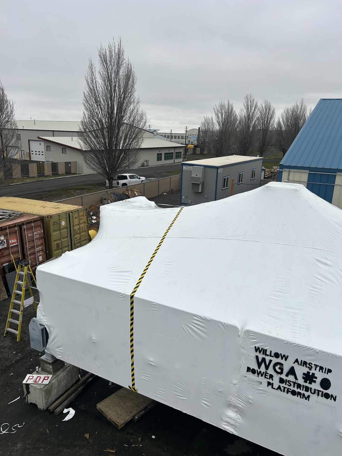 TCSW crew completing protective wrapping on a large industrial structure