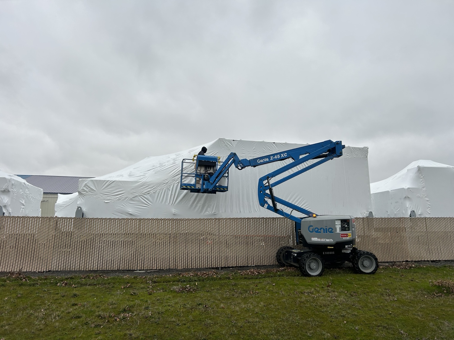 TCSW industrial shrink wrapping installation with aerial lift