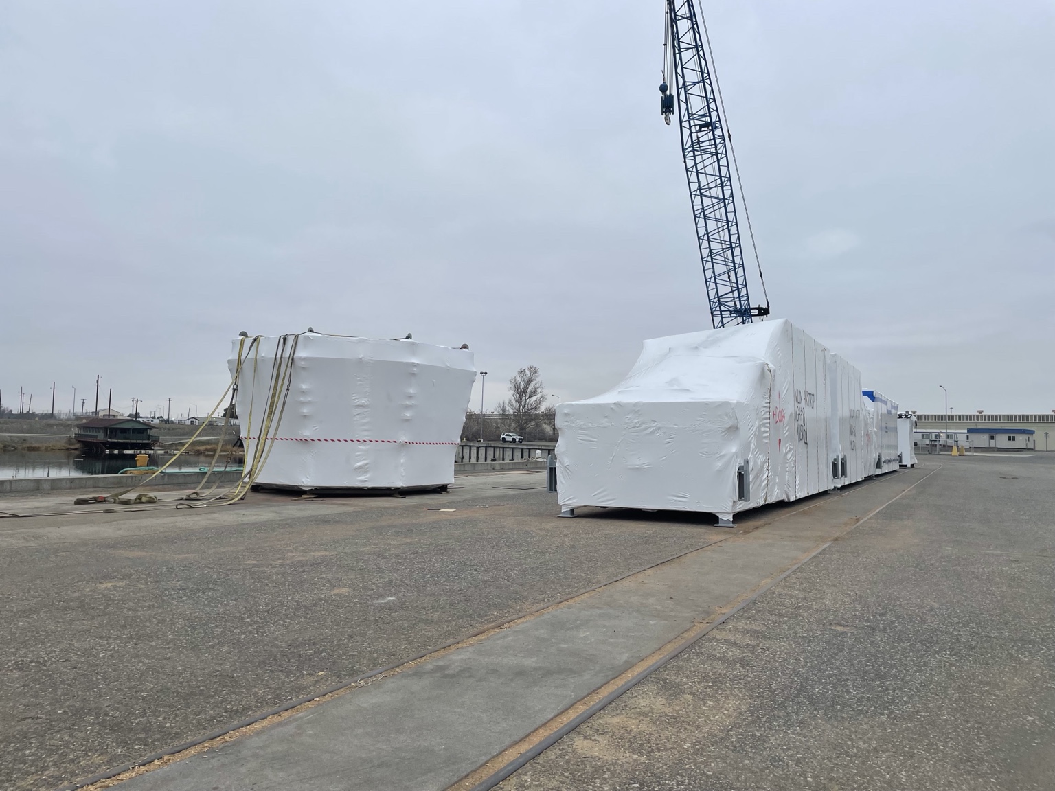 Wrapped industrial structures staged near shipping area